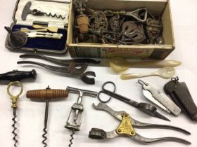 Group of antique and later corkscrews, Lund bottle opener, old penknife and other items