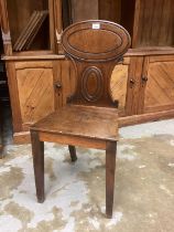 Regency mahogany hall chair with oval panelled back, solid seat on taper legs