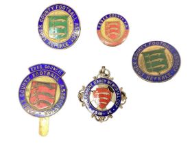 Group of five enamel football badges