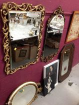 Two gilt framed wall mirrors, one other oval wall mirror, an oak framed mirror and two pictures (6)