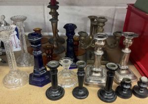 Group of glass and metal candlesticks.