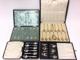 Set of Continental silver gilt sorbet spoons in fitted box, and three other sets of silver spoons