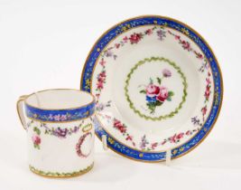 Sèvres cup and saucer, polychrome decorated with floral swags on a blue ground, initial 'C' to the f