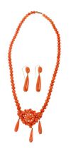 Victorian coral necklace with a cluster of coral beads suspending three pear shape coral pendant dro