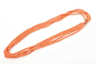 Antique coral long chain/guard chain with a long string of coral beads on gilt metal clasp.