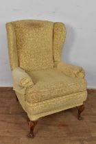 Queen Anne style wing armchair, raised on shell capped cabriole legs