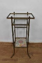 Glass three tier occasional table, on splayed supports, 60cm high