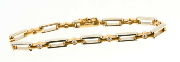 18ct white and yellow gold diamond bracelet with nine brilliant cut diamonds and articulated links,