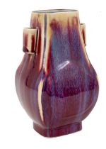 A Chinese sang-de-boeuf vase, of Hu form with arrow handles, with a streaked red and purple glaze, 1