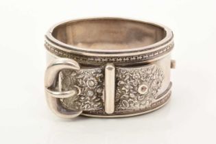 Victorian silver cuff bangle with belt and buckle design and floral decoration, 39mm wide.