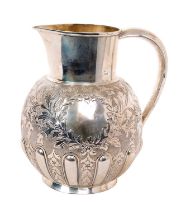 Late Victorian silver water jug with repoussé decoration