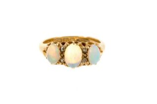 Edwardian opal and diamond ring with three oval cabochon opals interspaced by four diamonds in gold