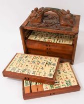 Antique Chinese bone and bamboo mahjong set, in wooden case with relief carved decoration