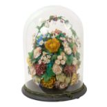 Glass dome housing an arrangements of shells in the form of flowers