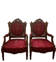 Pair of 19th century Continental carved gilt salon open armchairs