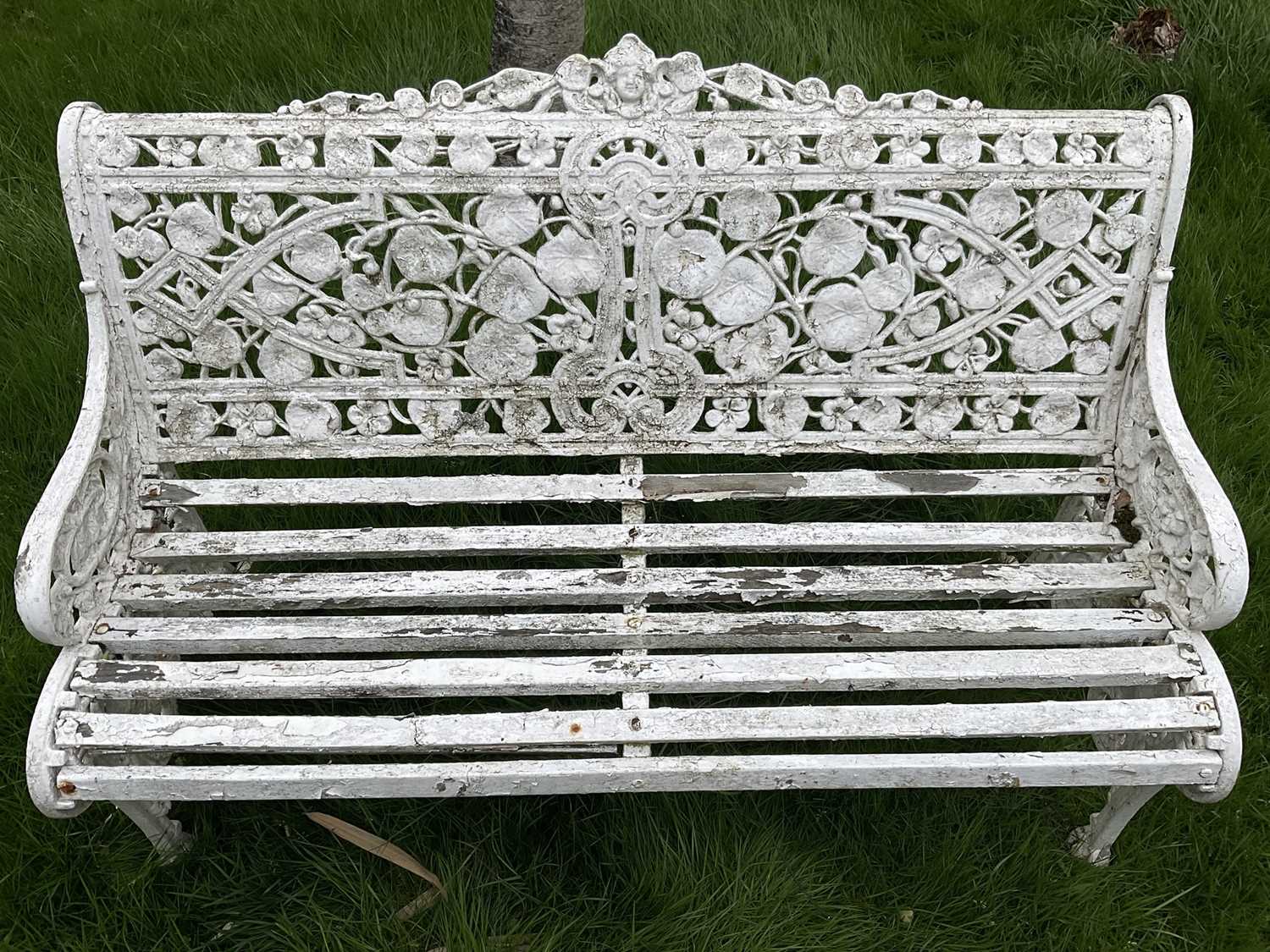 Victorian style white painted cast metal garden bench with lily pad and foliate design, 131cm wide. - Image 4 of 6