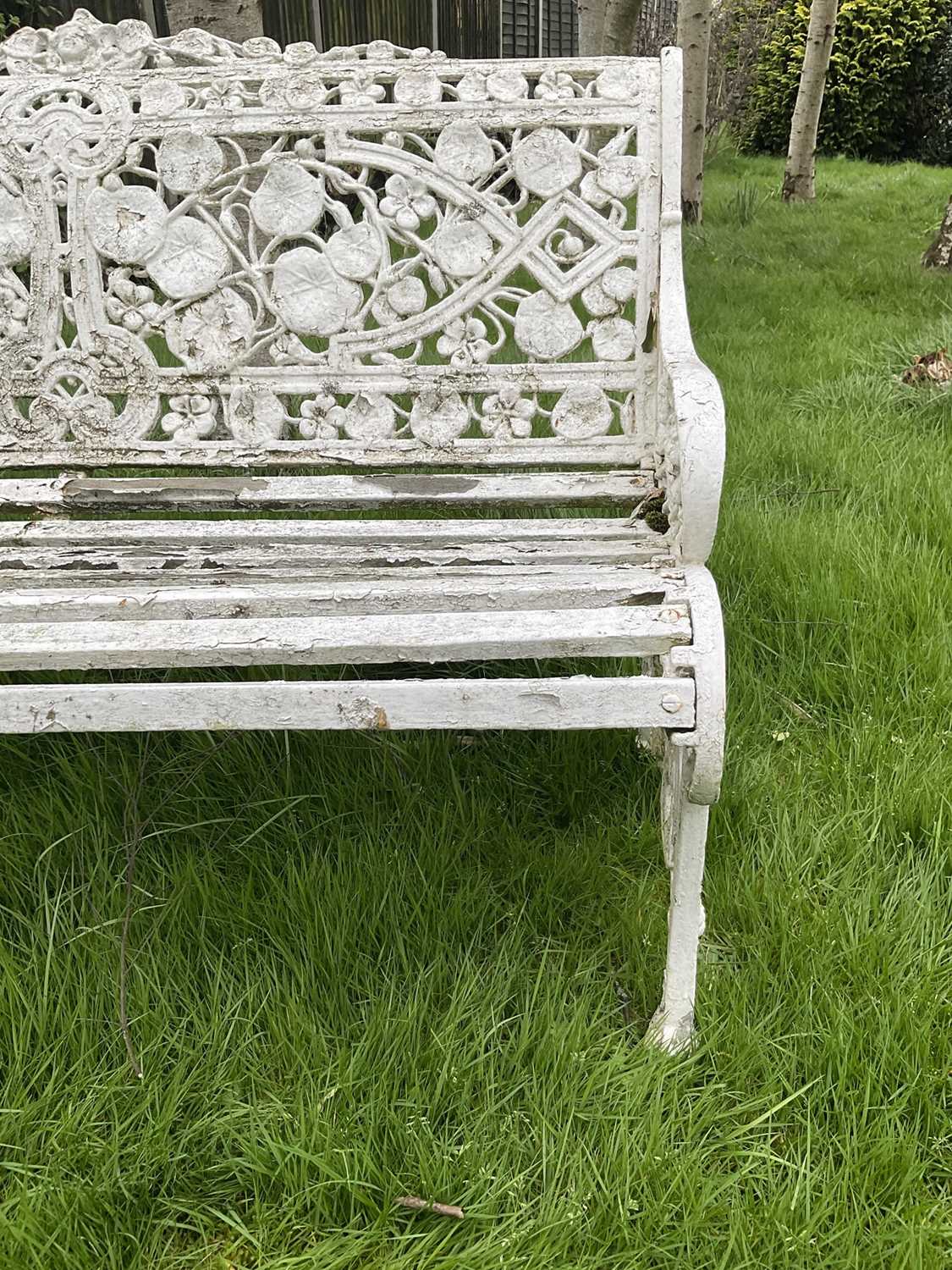 Victorian style white painted cast metal garden bench with lily pad and foliate design, 131cm wide. - Image 6 of 6