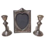 Contemporary silver photograph frame, with embossed decoration and a pair of candlesticks