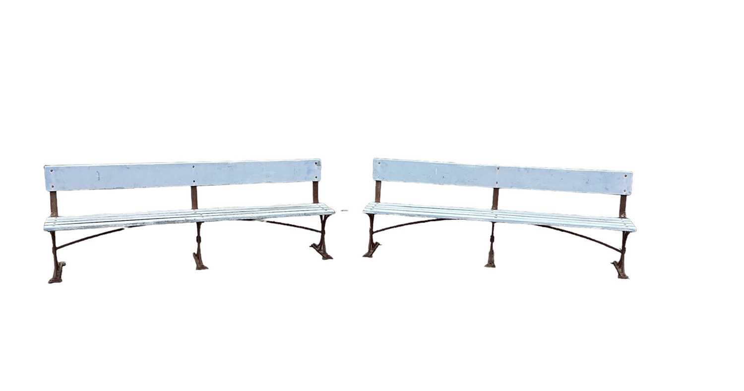 Large pair of antique wrought iron and slatted benches, 225cm wide
