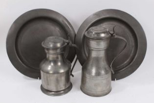 Pair of 18th century broad rimmed pewter plates and two pewter flagons