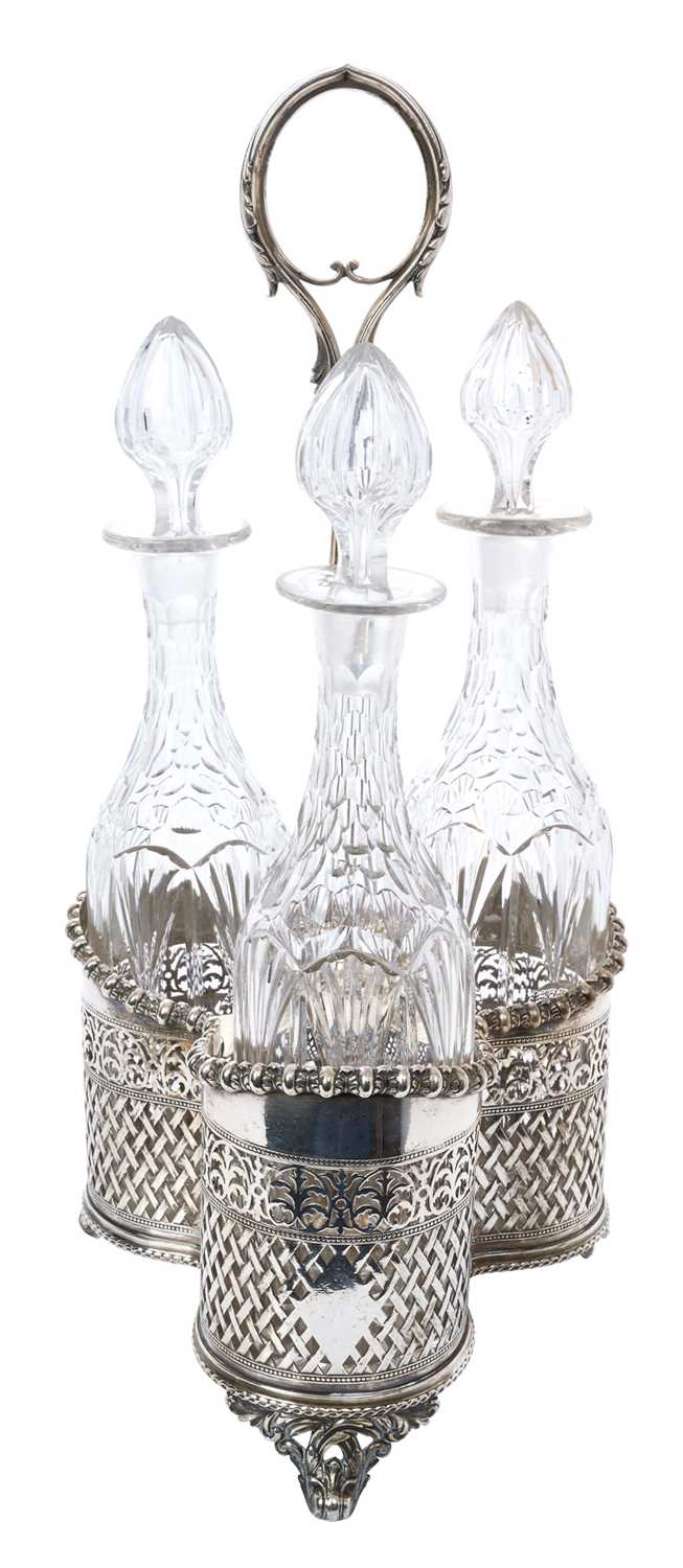 A good quality Dixon silver plated three-bottle decanter stand, with cut glass decanters