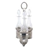 A good quality Dixon silver plated three-bottle decanter stand, with cut glass decanters