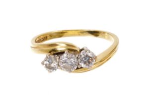 Diamond three stone ring with three brilliant cut diamonds in 18ct yellow gold crossover setting