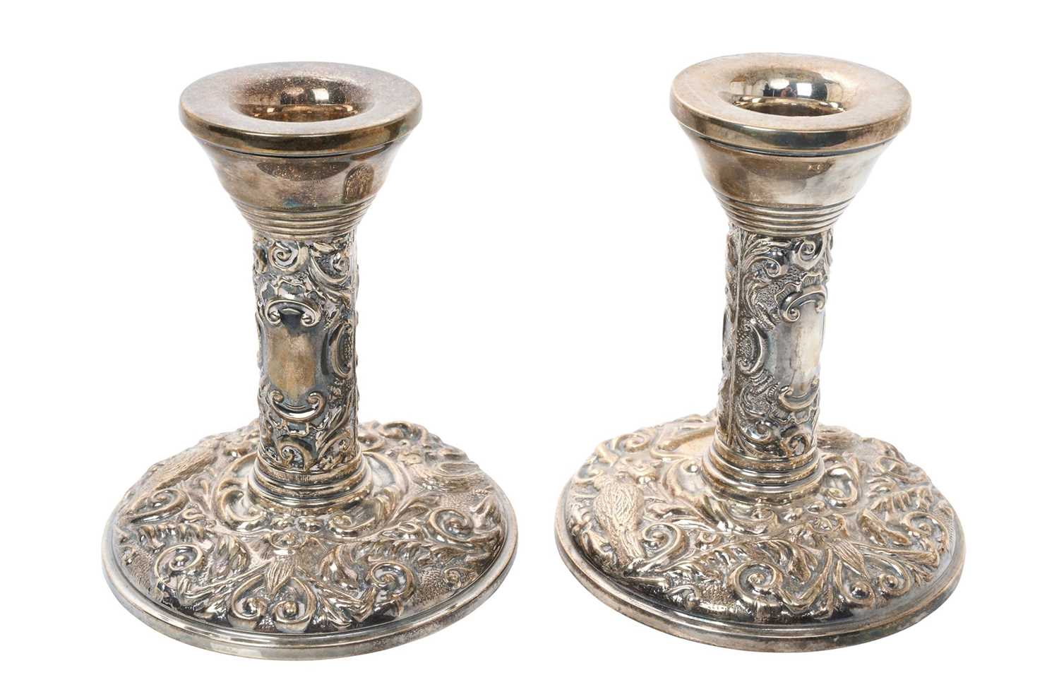Pair contemporary silver candlesticks, with embossed flora and fauna decoration