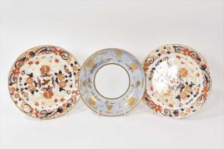 Pair of Wedgwood bone china plates, decorated in Imari style, and a saucer dish, decorated in pale b