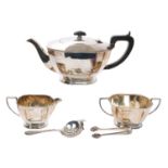 Silver three piece tea set with a tea strainer and sugar tongs