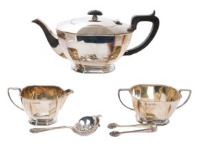 Silver three piece tea set with a tea strainer and sugar tongs