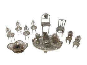 Collection of silver and white metal filigree items including small chairs, tray and other items.