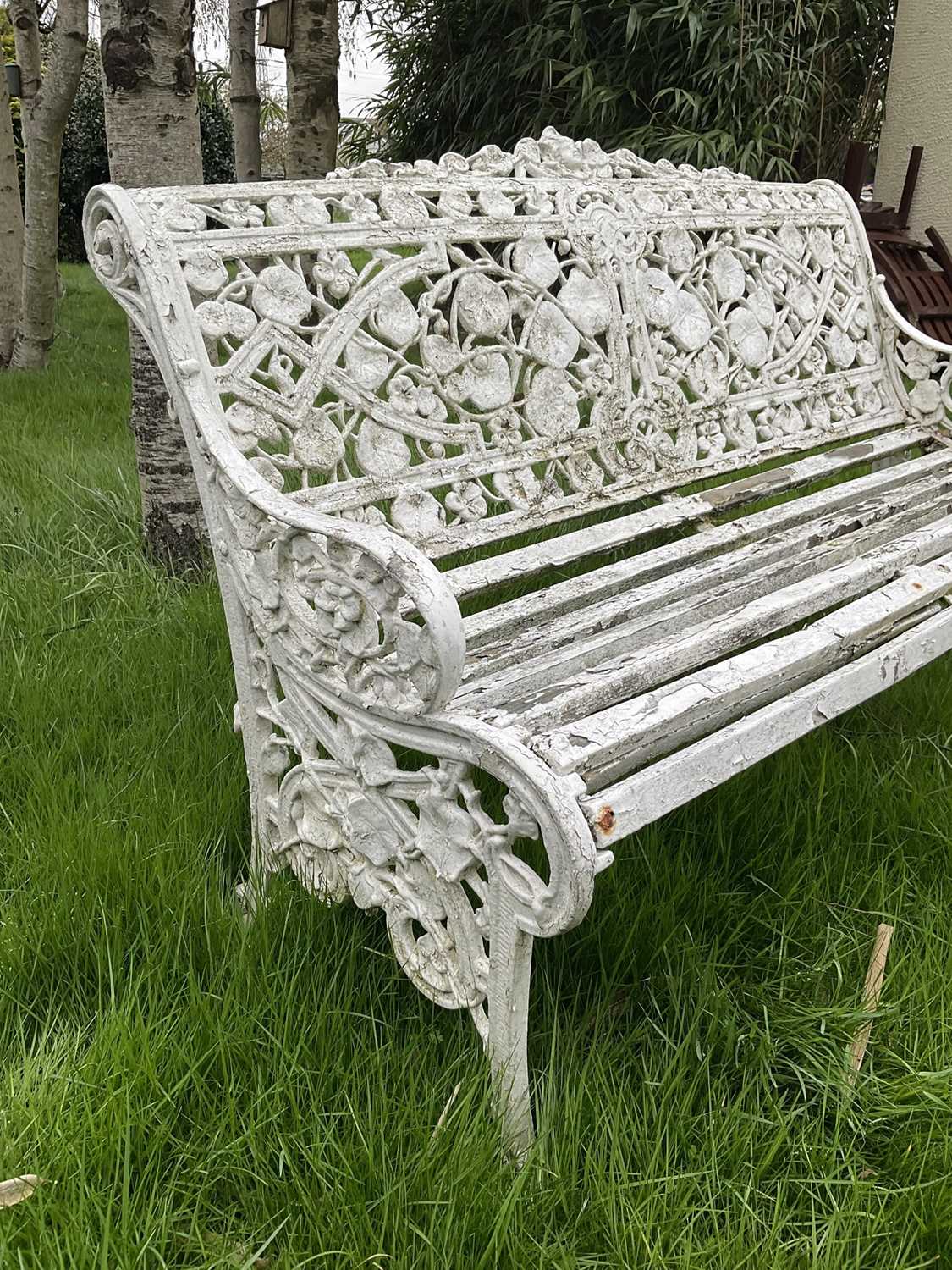 Victorian style white painted cast metal garden bench with lily pad and foliate design, 131cm wide. - Image 5 of 6