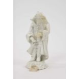 18th century white glazed porcelain figure of a man in a greatcoat, losses and restoration