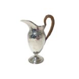 Edwardian silver hot water jug with wicker covered handle