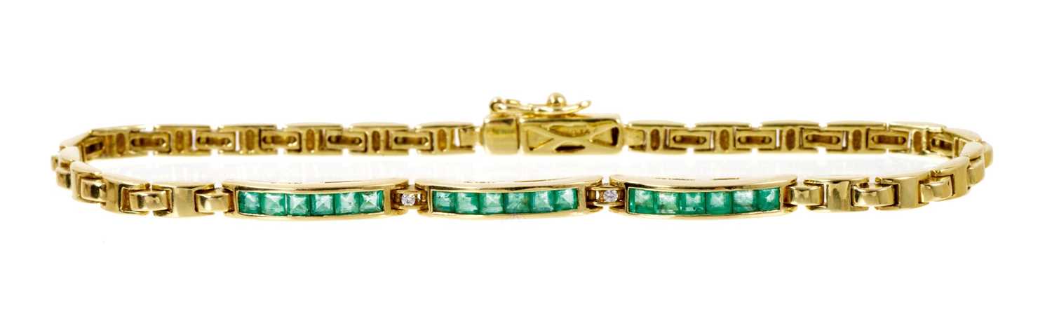 Emerald and diamond bracelet with three bands of calibre cut emeralds in channel setting interspaced