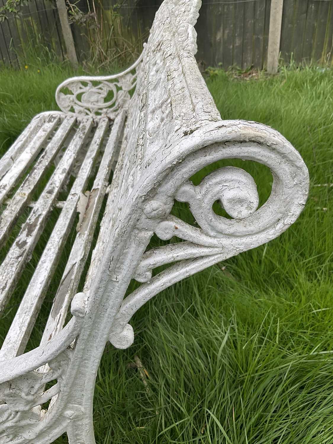 Victorian style white painted cast metal garden bench with lily pad and foliate design, 131cm wide. - Image 2 of 6