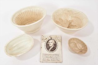 Four jelly moulds and a Wedgwood printed commemorative plaque