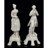 Near pair of 18th century Lowestoft white glazed porcelain figures of musicians, with losses