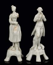 Near pair of 18th century Lowestoft white glazed porcelain figures of musicians, with losses