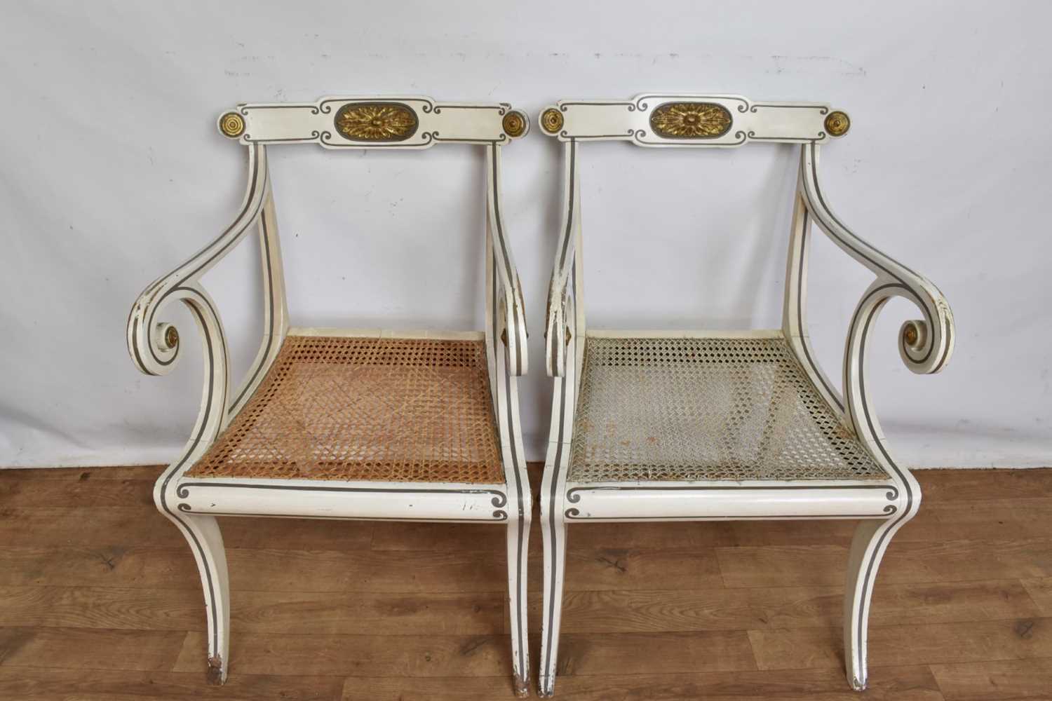 Pair of Regency style white painted and parcel gilt open elbow chairs with cane seats on sabre legs - Image 3 of 9