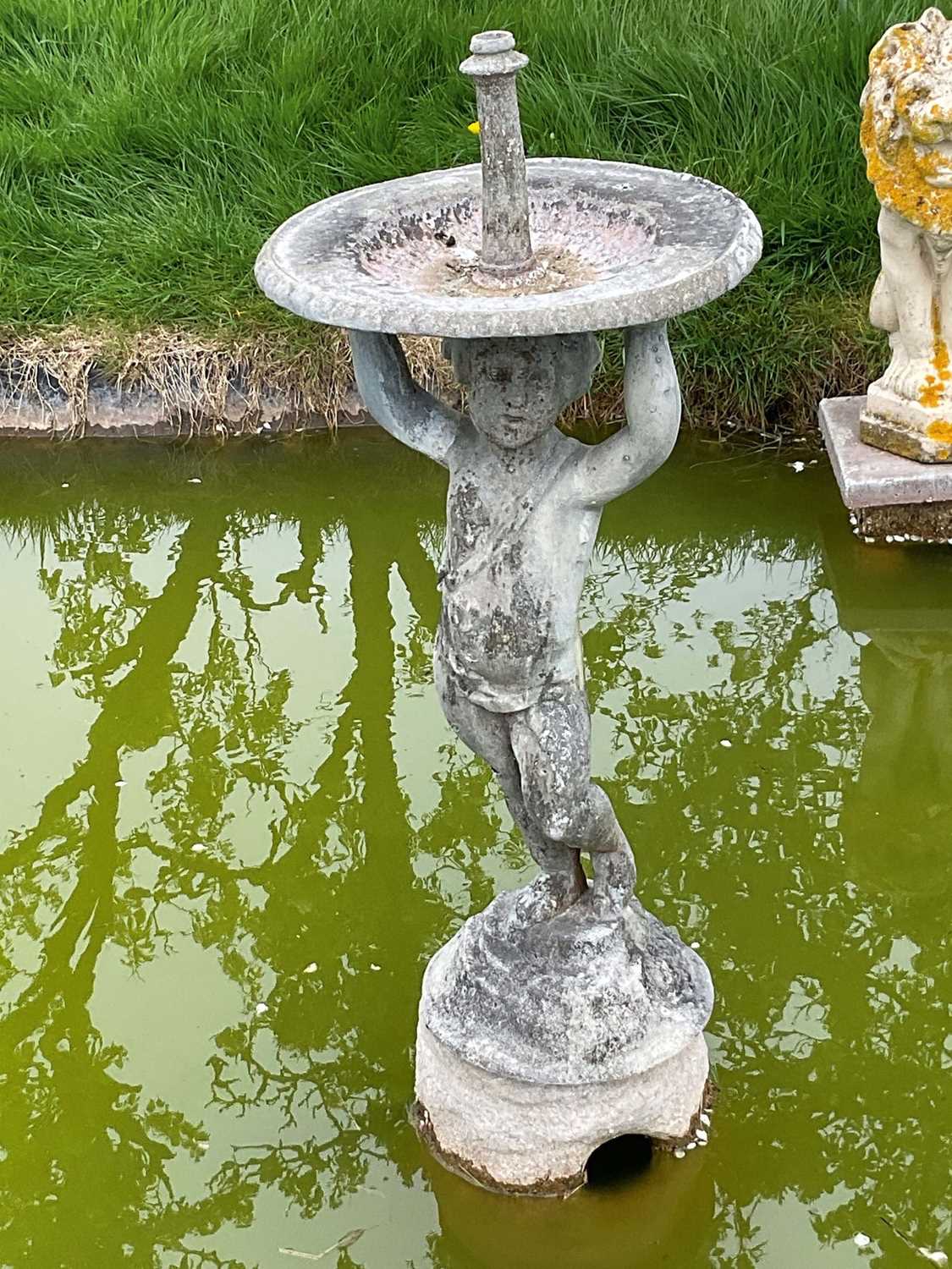 Antique lead garden fountain, the circular bowl with putti support on circular base.