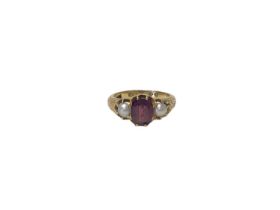 Early Victorian gold garnet and pearl three stone ring, the central oval mixed cut garnet flanked by