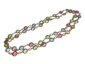 Multi-gem necklace with spectacle setting