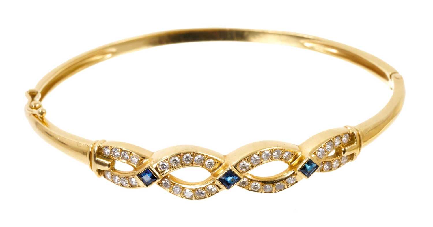 Sapphire and diamond hinged bangle with a platted design of single cut diamonds and three blue sapph