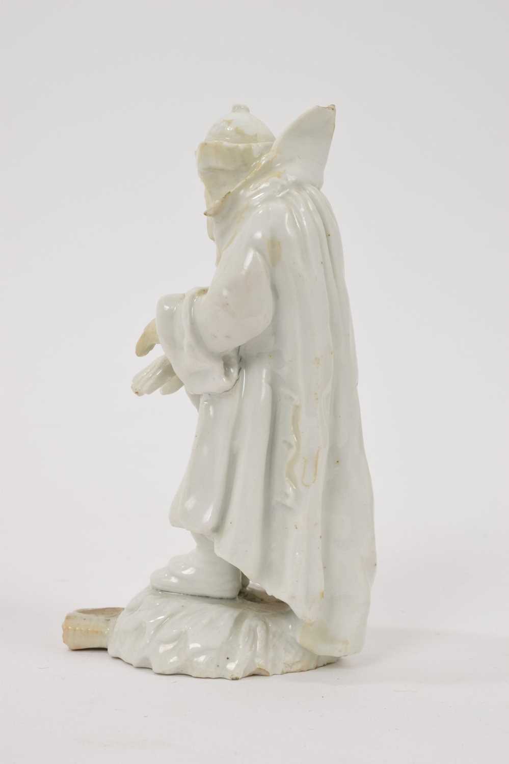 18th century white glazed porcelain figure of a man in a greatcoat, losses and restoration - Image 2 of 7