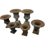 Six antique cast iron garden urns of campana form