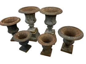 Six antique cast iron garden urns of campana form