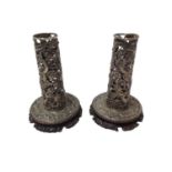 Pair of Chinese white metal candlesticks with pierced dragon decoration on carved wood bases