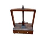 Regency mahogany table top book press with drawer on bun feet